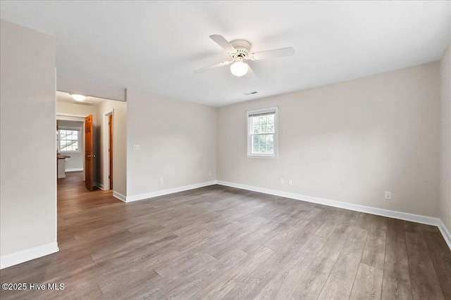 302 Mcglamery St, Oak Island, NC 28465 - unfurnished room with ceiling fan, baseboards, and wood finished floors