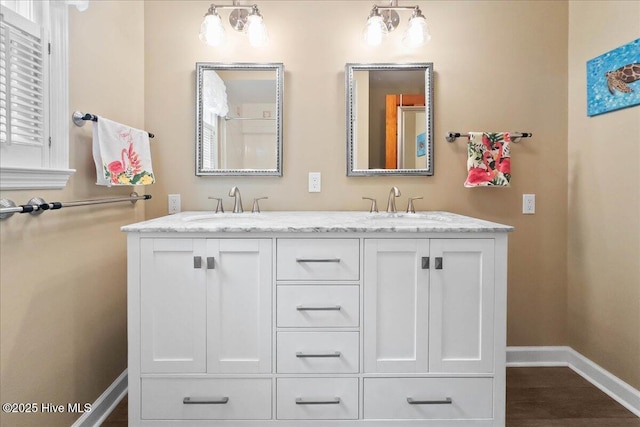 302 Mcglamery St, Oak Island, NC 28465 - bathroom featuring baseboards and double vanity