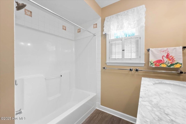 302 Mcglamery St, Oak Island, NC 28465 - full bathroom with baseboards, wood finished floors, shower / tub combination, and a sink