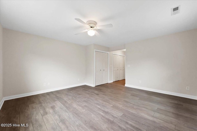 302 Mcglamery St, Oak Island, NC 28465 - spare room with a ceiling fan, wood finished floors, and baseboards