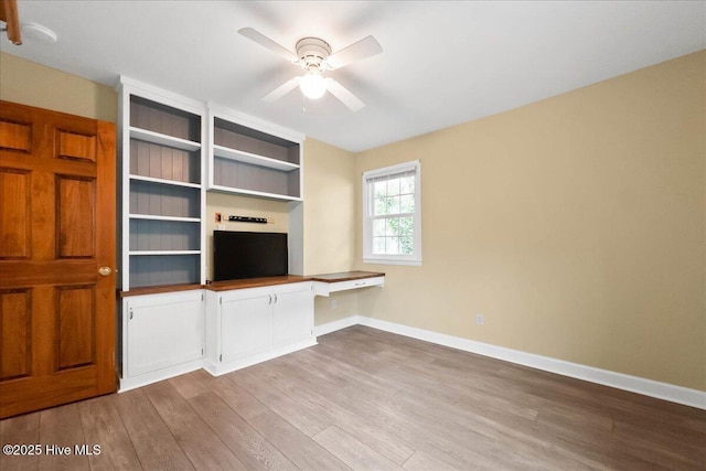 302 Mcglamery St, Oak Island, NC 28465 - unfurnished living room with wood finished floors, a ceiling fan, and baseboards