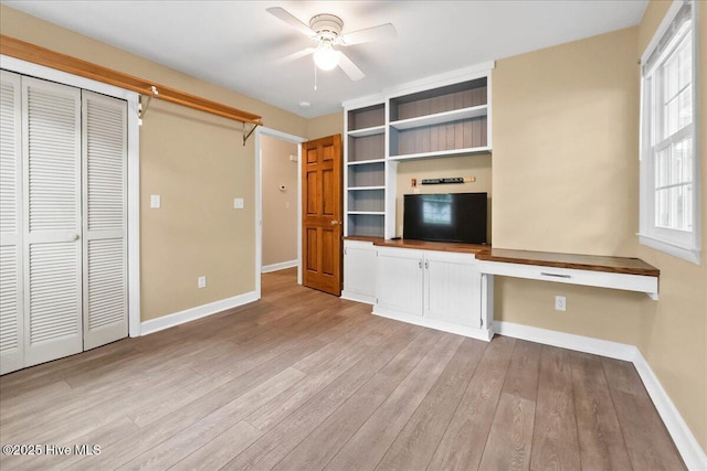 302 Mcglamery St, Oak Island, NC 28465 - unfurnished living room with ceiling fan, baseboards, and light wood-style flooring