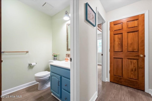 302 Mcglamery St, Oak Island, NC 28465 - bathroom with wood finished floors, vanity, baseboards, and toilet
