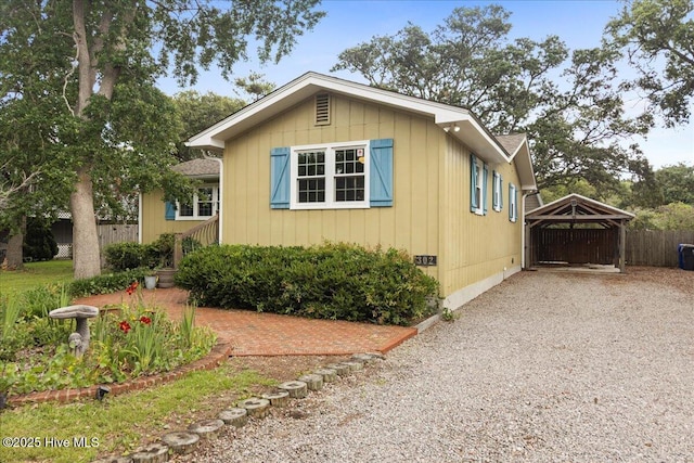 302 Mcglamery St, Oak Island, NC 28465 - view of front of home with a detached carport and driveway