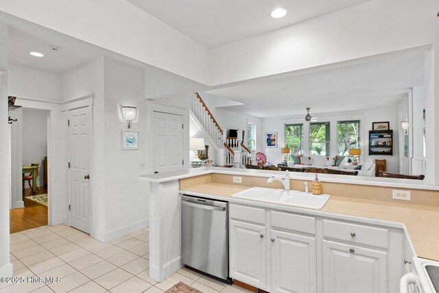 19 Sabal Palm Trl, Bald Head Island, NC 28461 - kitchen featuring white appliances, light tile patterned floors, white cabinetry, light countertops, and recessed lighting