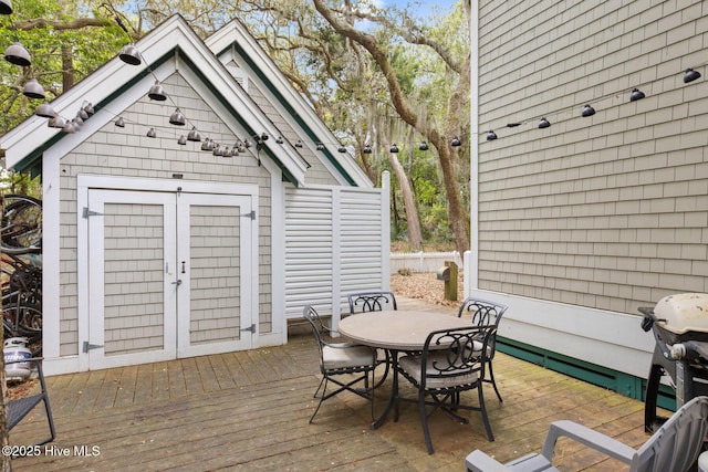 19 Sabal Palm Trl, Bald Head Island, NC 28461 - deck featuring outdoor dining area, a storage unit, and grilling area
