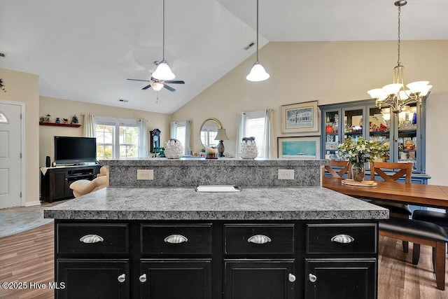 235 Chambers St, Winnabow, NC 28479 - kitchen with dark cabinets, a chandelier, ceiling fan, open floor plan, and light countertops