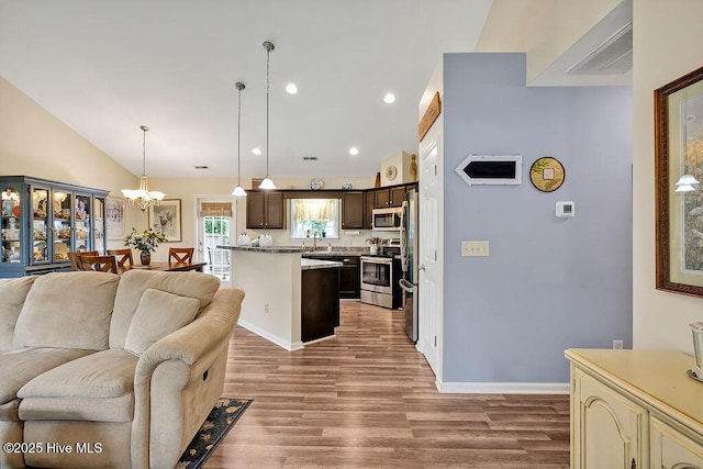 235 Chambers St, Winnabow, NC 28479 - living room with wood finished floors, a chandelier, vaulted ceiling, recessed lighting, and baseboards