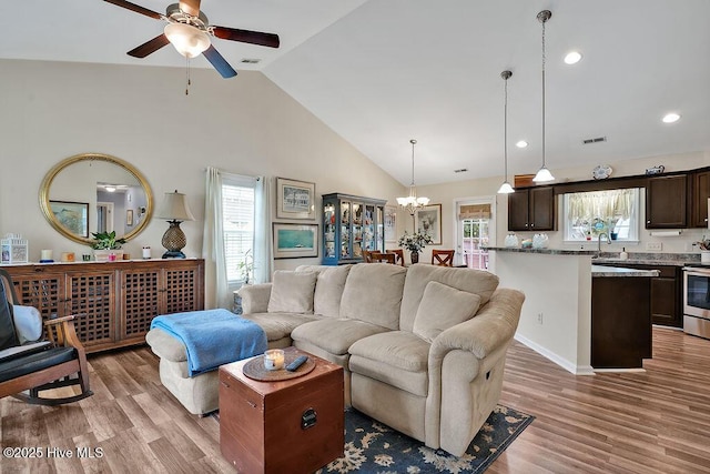 235 Chambers St, Winnabow, NC 28479 - living room with ceiling fan, light wood finished floors, a chandelier, high vaulted ceiling, and recessed lighting