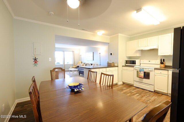 1116 E Ft Macon Rd, Atlantic Beach, NC 28512 - dining room with light wood-style floors, ornamental molding, a ceiling fan, and baseboards