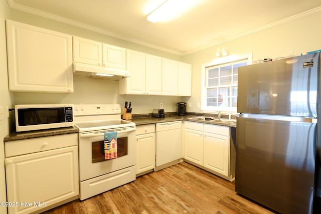 1116 E Ft Macon Rd, Atlantic Beach, NC 28512 - kitchen with white appliances, a sink, under cabinet range hood, dark countertops, and white cabinets