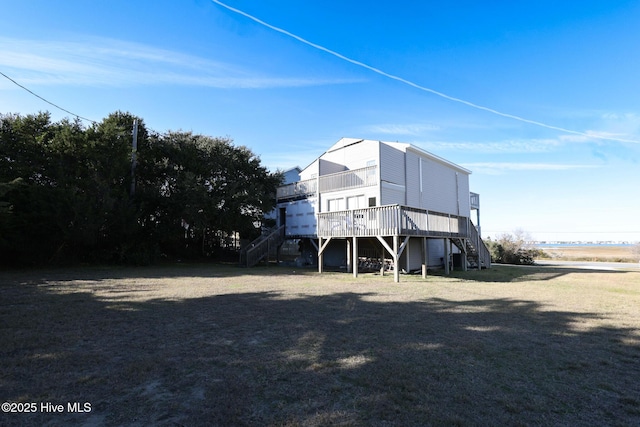 1116 E Ft Macon Rd, Atlantic Beach, NC 28512 - rear view of property featuring stairway, a wooden deck, and a yard