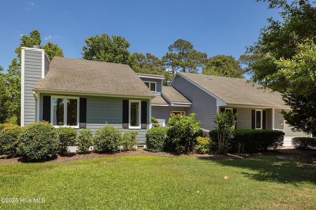 304 Lord Granville Dr, Morehead City, NC 28557 - view of front facade with a front lawn, a chimney, and a shingled roof