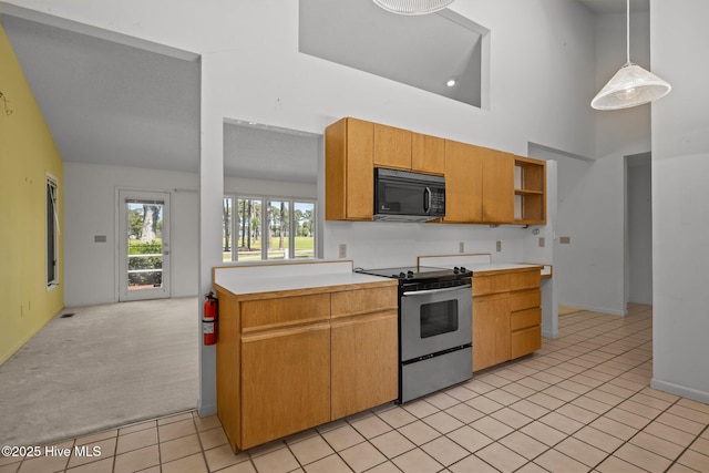 304 Lord Granville Dr, Morehead City, NC 28557 - kitchen featuring electric range, black microwave, light countertops, light tile patterned floors, and open shelves
