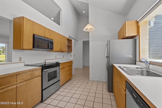 304 Lord Granville Dr, Morehead City, NC 28557 - kitchen with appliances with stainless steel finishes, a sink, light countertops, light tile patterned flooring, and high vaulted ceiling