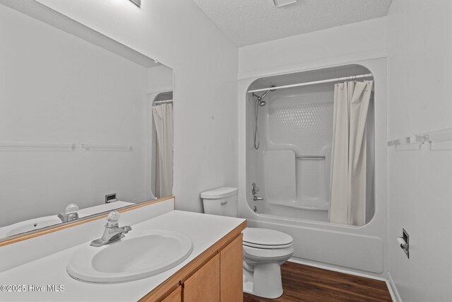 304 Lord Granville Dr, Morehead City, NC 28557 - bathroom with vanity, toilet, a textured ceiling, shower / bath combination with curtain, and wood finished floors