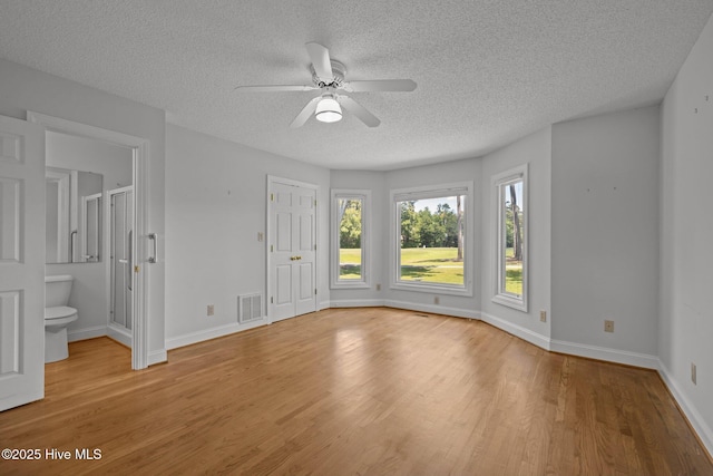 304 Lord Granville Dr, Morehead City, NC 28557 - spare room featuring a textured ceiling, a ceiling fan, light wood finished floors, and baseboards