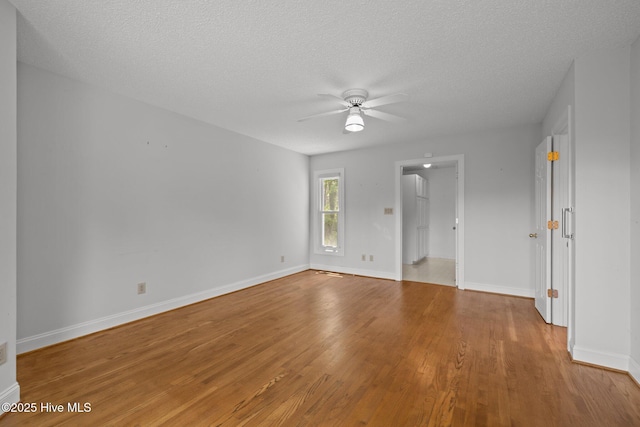 304 Lord Granville Dr, Morehead City, NC 28557 - spare room with wood finished floors, a ceiling fan, baseboards, and a textured ceiling