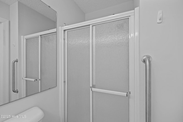 304 Lord Granville Dr, Morehead City, NC 28557 - full bathroom featuring a textured ceiling, a shower stall, and toilet