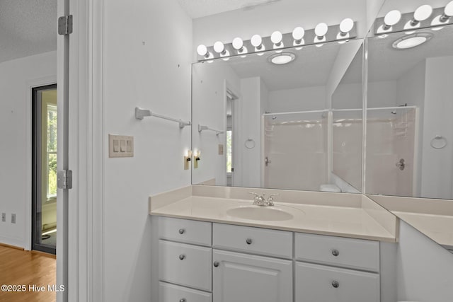 304 Lord Granville Dr, Morehead City, NC 28557 - full bath with vanity, a shower with door, healthy amount of natural light, and a textured ceiling