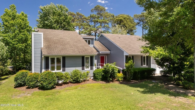 304 Lord Granville Dr, Morehead City, NC 28557 - view of front of home featuring a front yard, roof with shingles, and a chimney