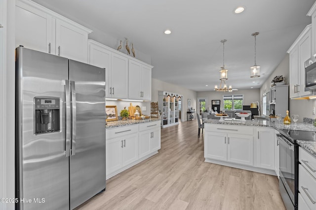 104 S 30th St, Morehead City, NC 28557 - kitchen with stainless steel fridge with ice dispenser, electric range, open floor plan, a peninsula, and white cabinetry
