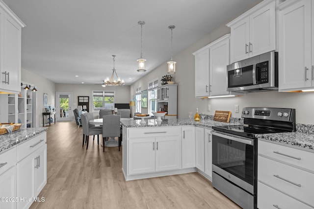 104 S 30th St, Morehead City, NC 28557 - kitchen with appliances with stainless steel finishes, light wood-type flooring, a chandelier, open floor plan, and recessed lighting