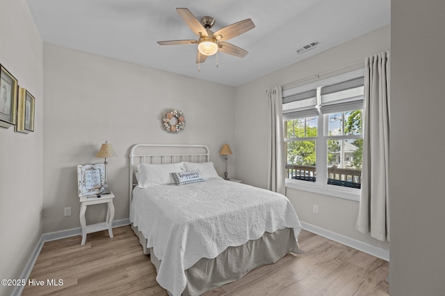 104 S 30th St, Morehead City, NC 28557 - bedroom with wood finished floors, baseboards, and a ceiling fan
