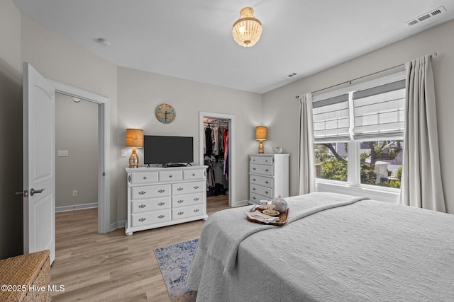 104 S 30th St, Morehead City, NC 28557 - bedroom featuring a spacious closet, light wood-type flooring, baseboards, and a closet