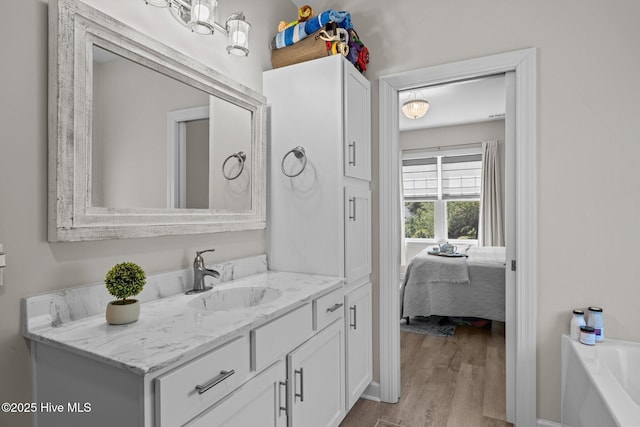 104 S 30th St, Morehead City, NC 28557 - ensuite bathroom with vanity, wood finished floors, and a bathtub