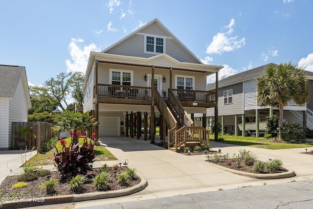 104 S 30th St, Morehead City, NC 28557 - coastal home with a porch, concrete driveway, stairway, and a garage