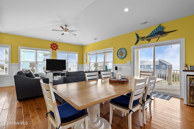 2414 Ocean Dr, Emerald Isle, NC 28594 - dining area featuring a wainscoted wall, a ceiling fan, and hardwood / wood-style flooring