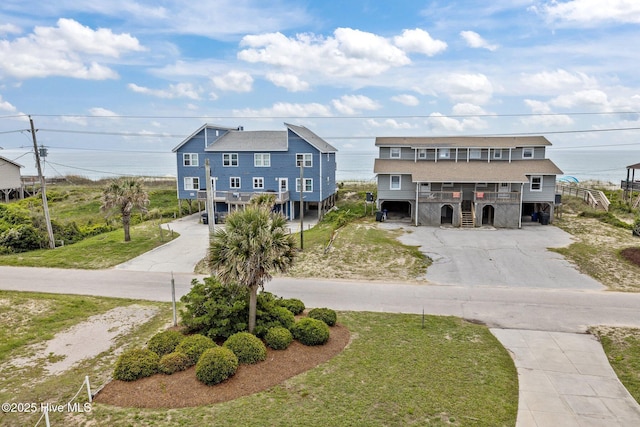 2414 Ocean Dr, Emerald Isle, NC 28594 - view of front of house featuring driveway, a front lawn, and stairs