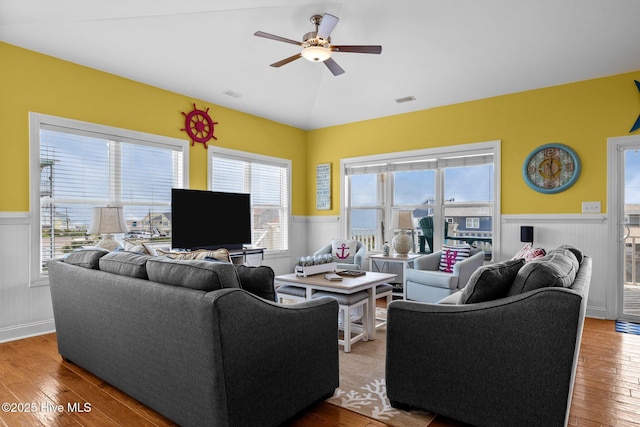 2414 Ocean Dr, Emerald Isle, NC 28594 - living room featuring wainscoting, ceiling fan, wood finished floors, healthy amount of natural light, and vaulted ceiling