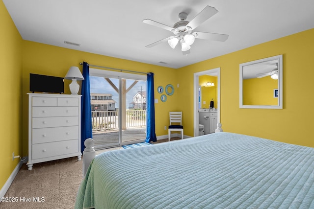 2414 Ocean Dr, Emerald Isle, NC 28594 - carpeted bedroom featuring access to exterior, baseboards, ceiling fan, and ensuite bath