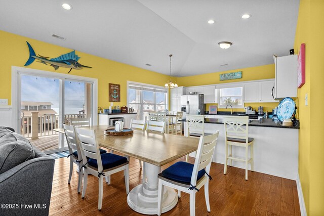 2414 Ocean Dr, Emerald Isle, NC 28594 - dining space with plenty of natural light, wood finished floors, a chandelier, recessed lighting, and vaulted ceiling