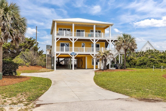 2414 Ocean Dr, Emerald Isle, NC 28594 - coastal inspired home featuring a carport, stairs, a front yard, and driveway