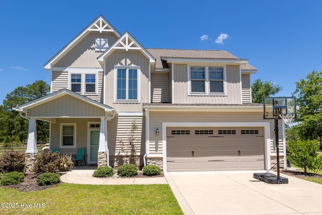 111 Pinelands Vis, Jackson Springs, NC 27281 - craftsman-style home featuring board and batten siding, a garage, concrete driveway, stone siding, and covered porch