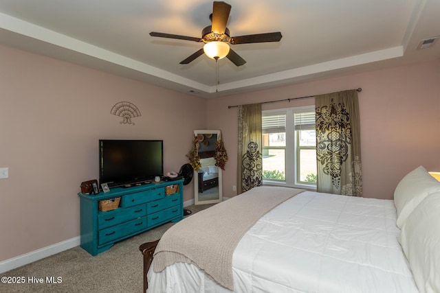 111 Pinelands Vis, Jackson Springs, NC 27281 - carpeted bedroom featuring a tray ceiling, baseboards, and ceiling fan