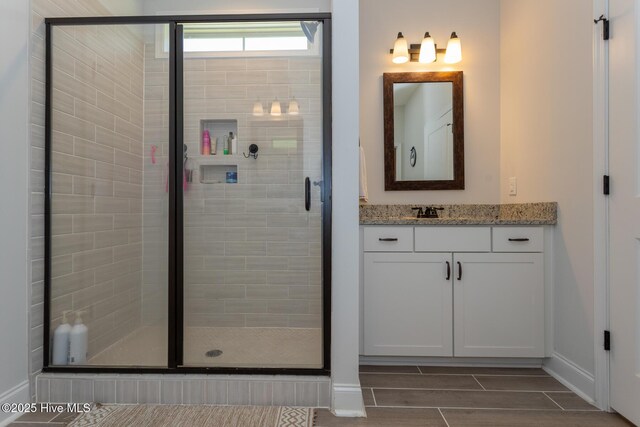 111 Pinelands Vis, Jackson Springs, NC 27281 - bathroom with baseboards, vanity, and a stall shower