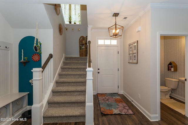 111 Pinelands Vis, Jackson Springs, NC 27281 - foyer entrance with a chandelier, dark wood-style floors, stairs, baseboards, and crown molding