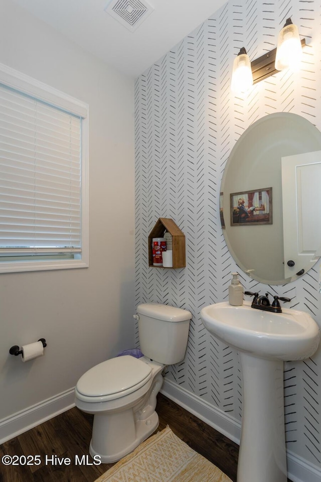 111 Pinelands Vis, Jackson Springs, NC 27281 - bathroom featuring wood finished floors, toilet, baseboards, and wallpapered walls