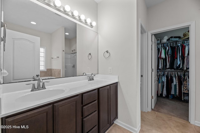 3412 Lefringhouse Ln, New Bern, NC 28562 - bathroom featuring double vanity, a spacious closet, tile patterned floors, and a shower