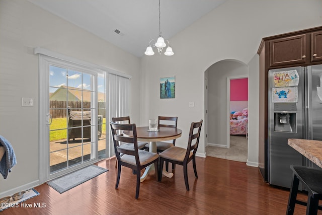 3412 Lefringhouse Ln, New Bern, NC 28562 - dining area featuring arched walkways, a chandelier, dark wood finished floors, lofted ceiling, and baseboards