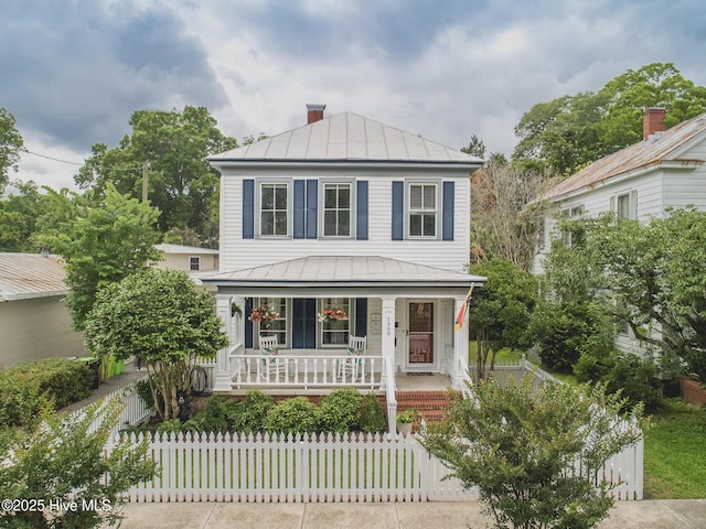 1309 N Pasteur St, New Bern, NC 28560 - view of front of house featuring a standing seam roof, covered porch, a metal roof, and a fenced front yard