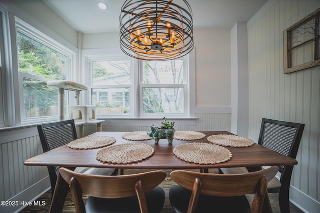 1309 N Pasteur St, New Bern, NC 28560 - dining room with healthy amount of natural light, a chandelier, wood finished floors, and wood walls