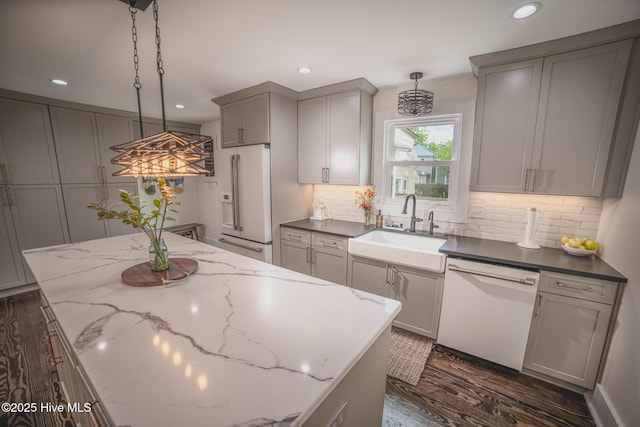 1309 N Pasteur St, New Bern, NC 28560 - kitchen featuring white appliances, gray cabinets, dark wood finished floors, a kitchen island, and recessed lighting