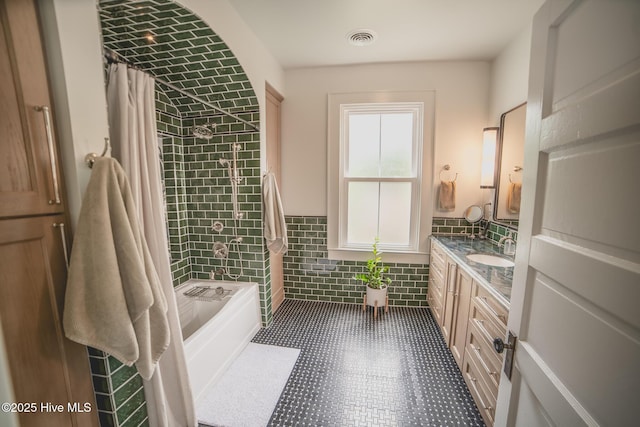 1309 N Pasteur St, New Bern, NC 28560 - full bath with vanity, tile walls, wainscoting, and shower / bathtub combination with curtain