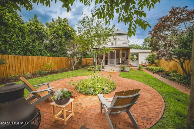 1309 N Pasteur St, New Bern, NC 28560 - back of property with a sunroom, a patio area, and a fenced backyard