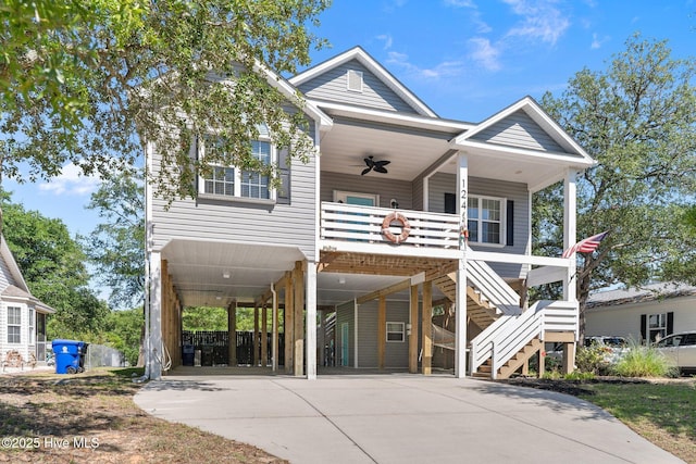 124 NE 35th St, Oak Island, NC 28465 - raised beach house featuring a carport, ceiling fan, driveway, covered porch, and stairway